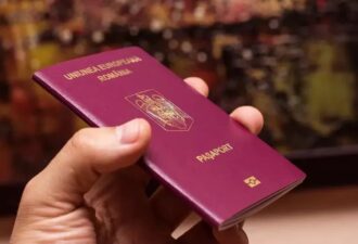 Паспорт Румунії в руках, символ європейської ідентичності та можливостей подорожей.